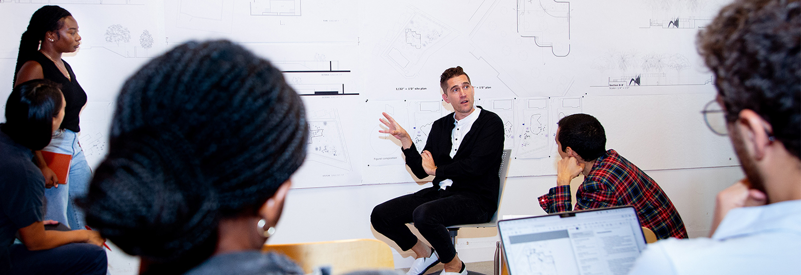 Joel Lamere (center), professor and director of the graduate program in the School of Architecture, conducts a review of first year graduate students' first project of the semester in the Thomas P. Murphy Design Studio Building.
