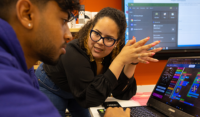 Lorena Lopez, lecturer at School of Communication, speaks with her student during class.